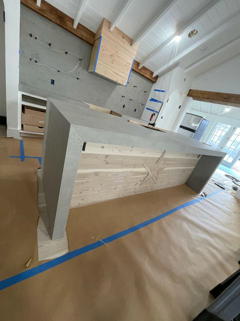 Stone island countertop being set and fitted on site during an installation